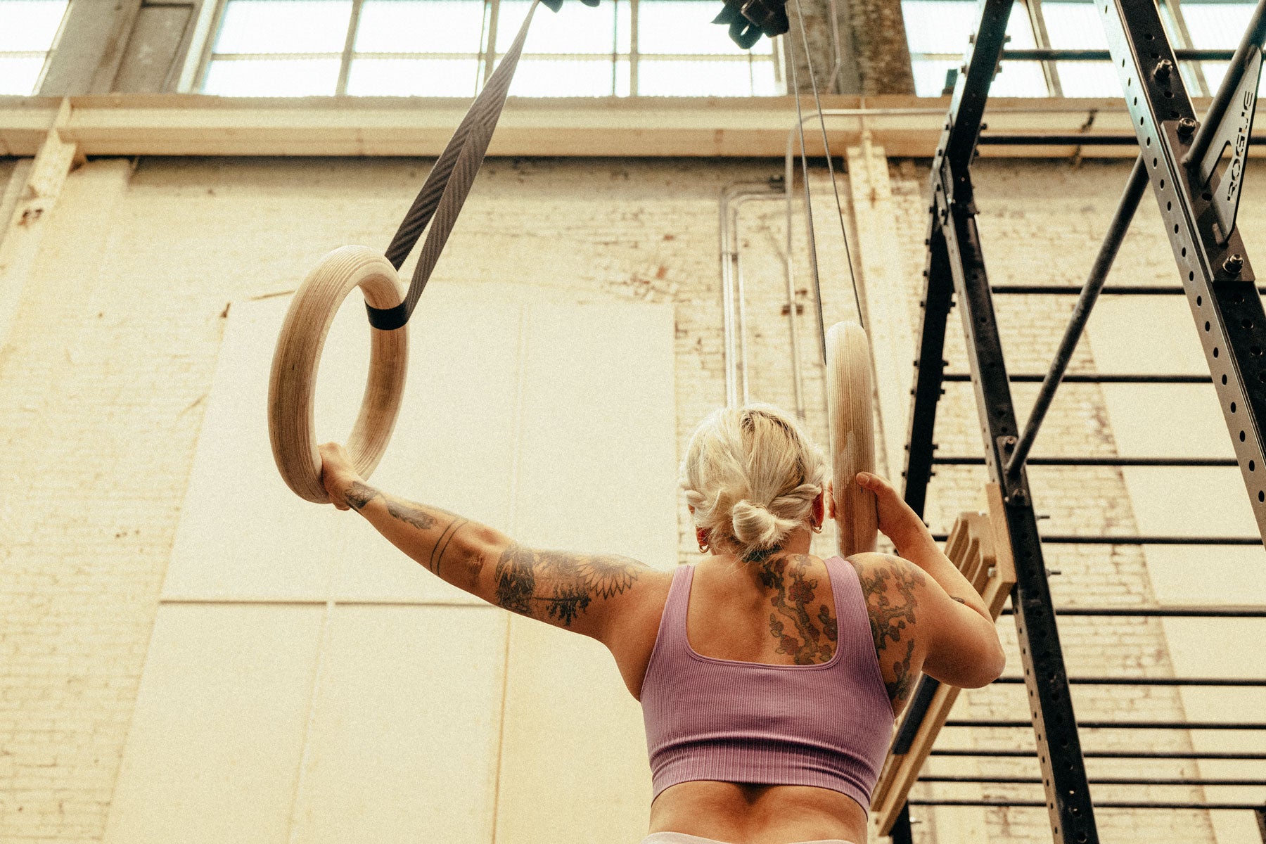 A woman works out on Meagan Martin's mega wooden rings