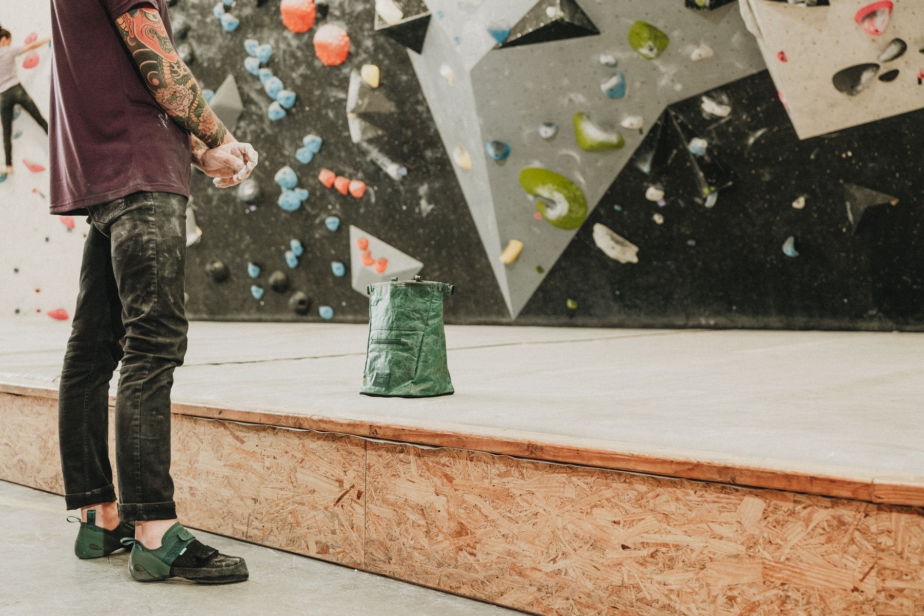 a man gets ready to climb at climb so ill while using the cypress green tyvek chalk bucket