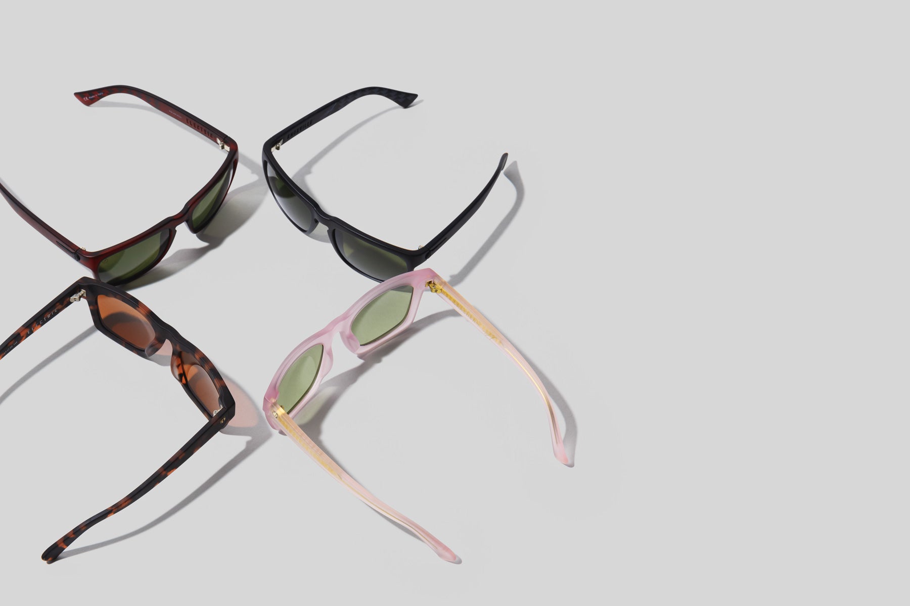 all electric sunglasses shown together on a grey background