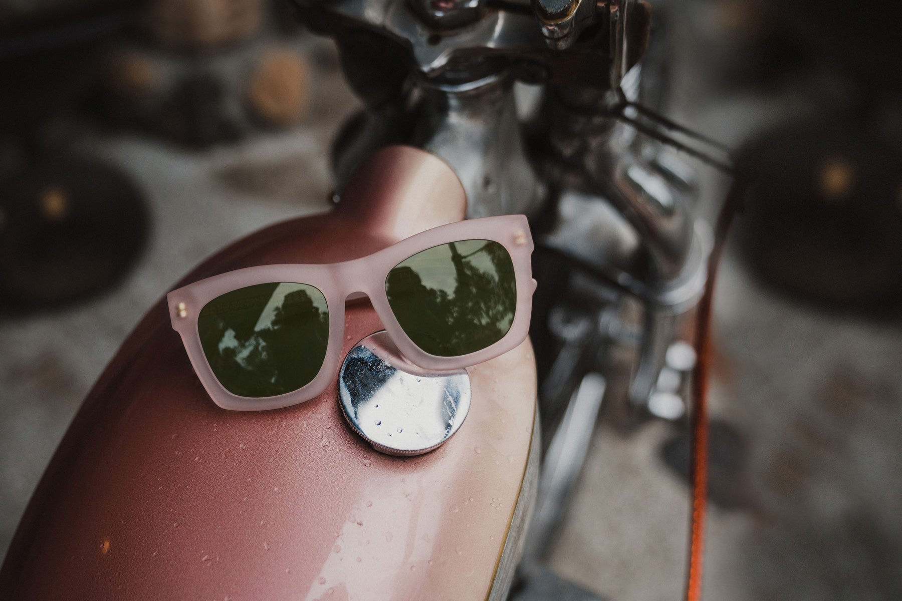 on the roam x electric matte pink sunglasses on a hand made motorcycle