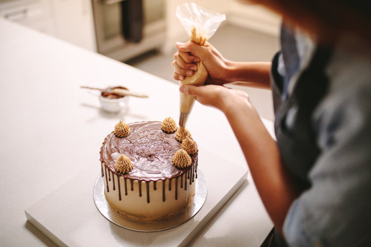 Decorating a chocolate cake made with Dutch-Process Cocoa Powder