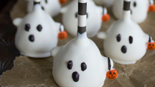 hese Trick-Or-Treat Ghost Cake Pops are a deliciously adorable addition to any Halloween spread.
