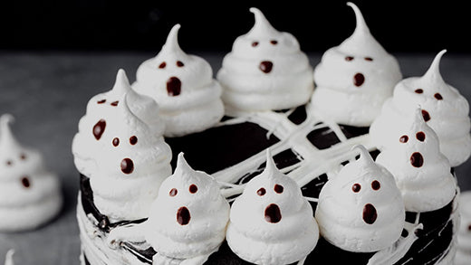 Looking for the perfect Halloween cake?? Look no further than this black cocoa cake covered in black cocoa buttercream and topped with marshmallow spiderwebs and ghost meringues!
