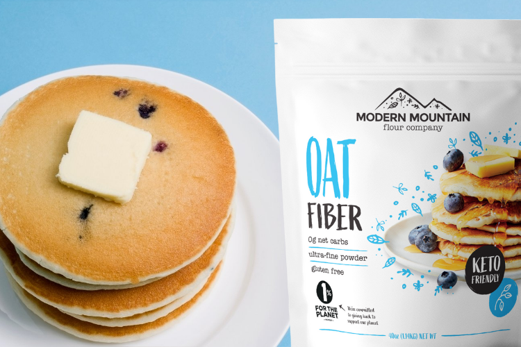 Pouch of Modern Mountain Oat Fiber in front of a stack of low-carb blueberry pancakes