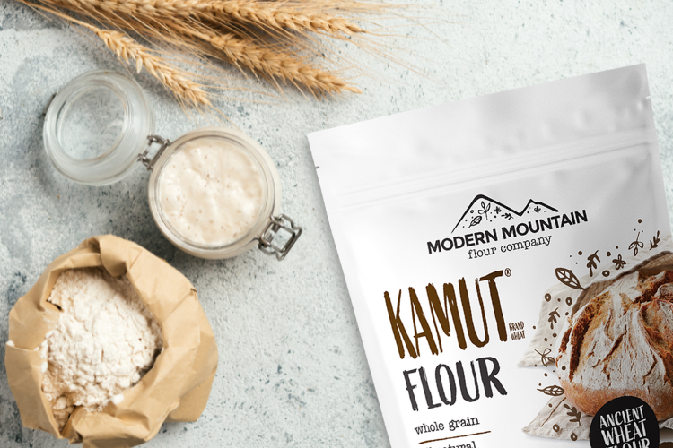 Pouch of Modern Mountain KAMUT flour next to flour, wheat, and sourdough starter