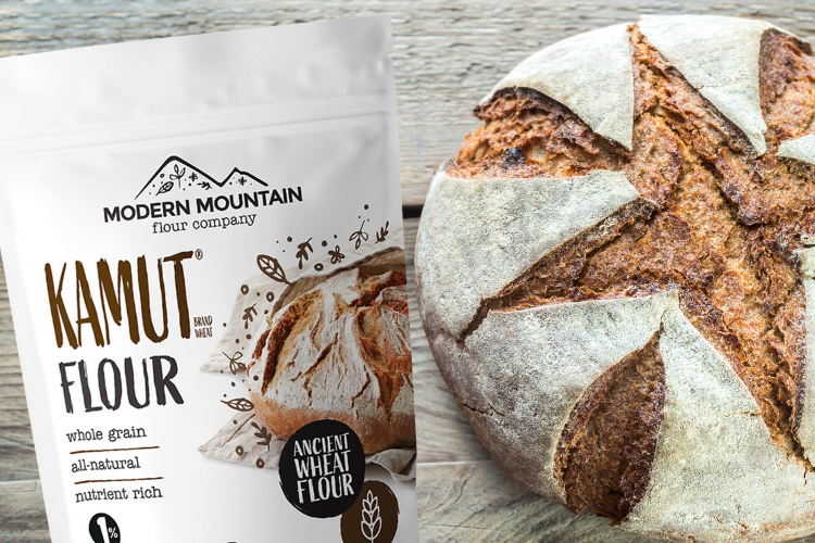 A pouch of Modern Mountain KAMUT Flour next to a loaf of KAMUT flour bread