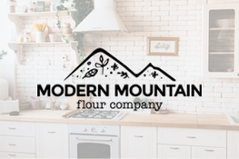 Modern mountain flour company logo overlaid on a kitchen background
