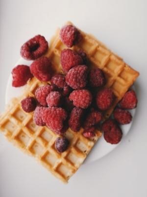 Low-carb waffles topped with raspberries