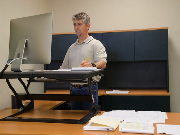 man using a standing desk