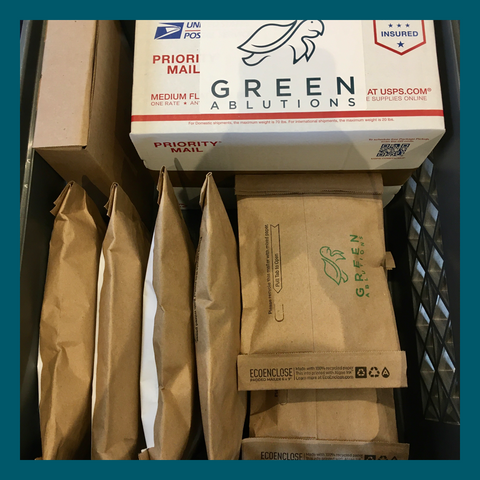 Packages of Green Ablutions solid shampoo and solid conditioner bars ready to ship for holiday shopping. Green Ablutions are the best bar shampoo and best bar conditioner for travel. Green Ablutions shampoo bars and conditioner bars are sustainable, vegan, eco-friendly and plastic-free holiday gifts.