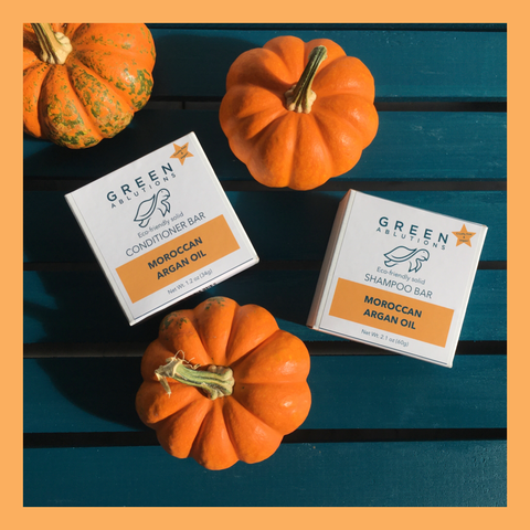 Green Ablutions Moroccan Argan Oil Shampoo and Conditioner Bars on a teal background with three small pumpkins. The best shampoo bars and the best conditioner bars for curly hair! Sustainable haircare that’s vegan, zero-waste and plastic free with compostable paper packaging.