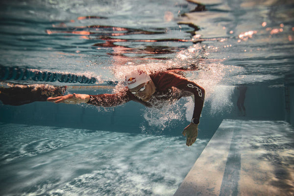 triathlete swim training in wetsuit