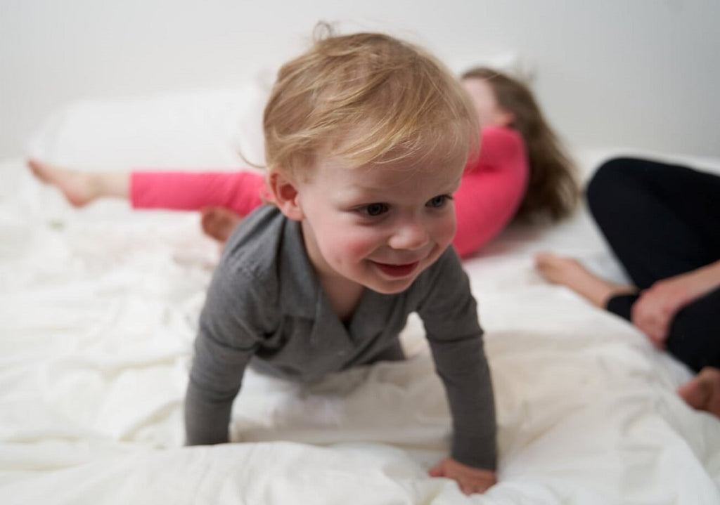 boy crawling in Weekend Made pajama set