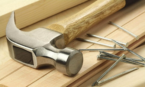 hammer and nails on a wooden panel