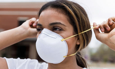 Lady putting on a N95 mask