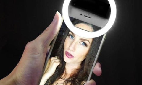 Ringlight on a phone of a woman taking a selfie