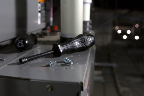 Screwdriver and screws on a table.