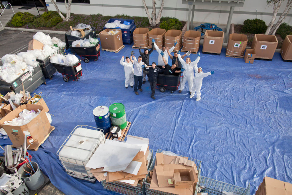 Dr. Bronner employees sort through the waste.