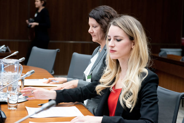 Participants in a courtroom.