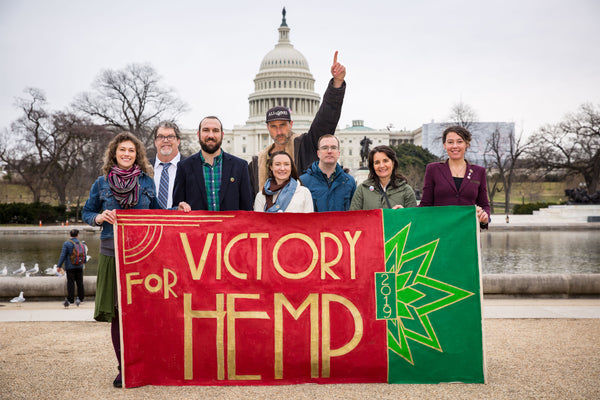 Hemp activists and Dr. Bronner's staff stand triumphantly on Capitol Hill behind a banner that reads "VICTORY FOR HEMP."