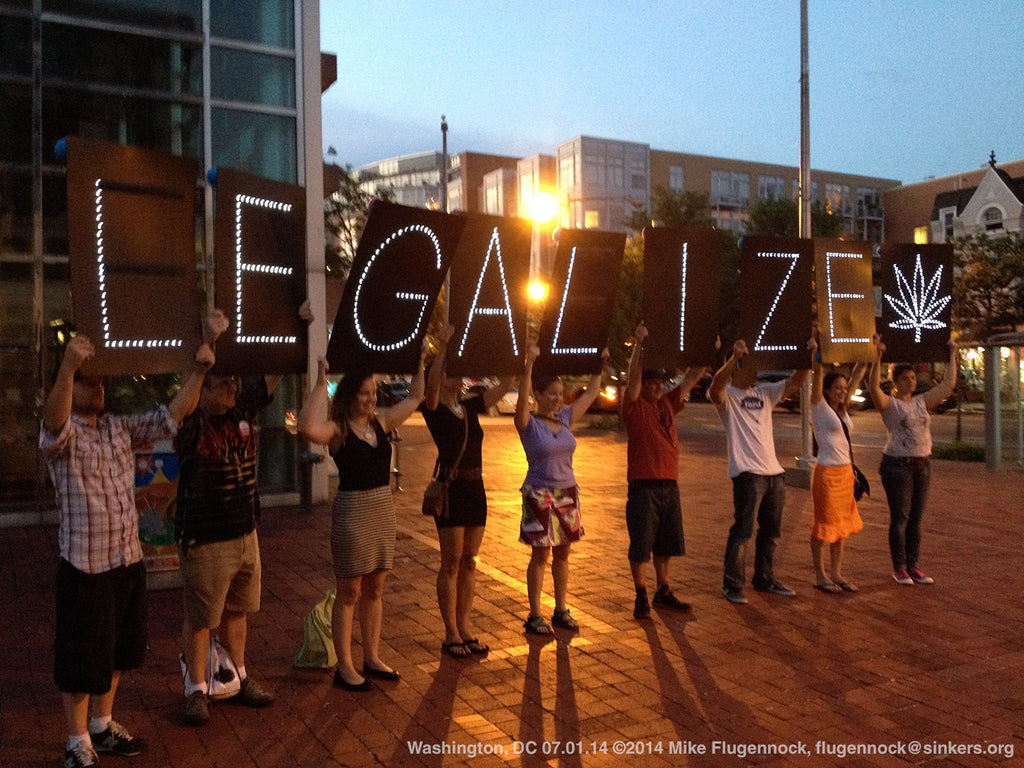 Cannabis activists holding signs when combined read "Legalize".