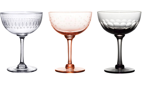Champagne saucer with oval design, £16. Rose champagne saucer with stars design, £17. Smoky champagne saucer with lens design, £16.
