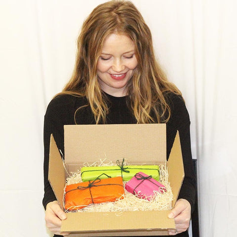 Woman holding a parcel with colourfully wrapped items