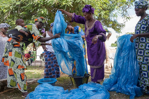 Gambian women washing the air freight plastic wrap