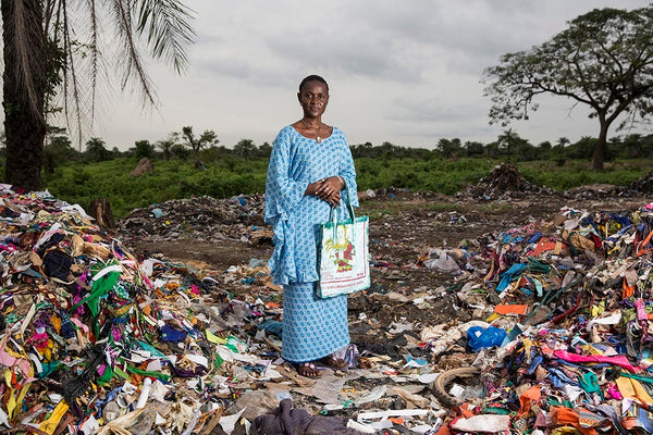 Isatou Ceessay, Climate Hero, standing within a landfill in her home country, The Gambia