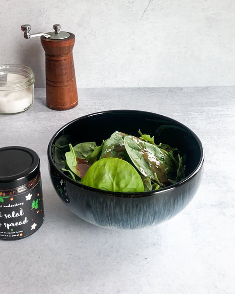 Jam jar vinaigrette on salad greens with a jar of wild salal berry spread