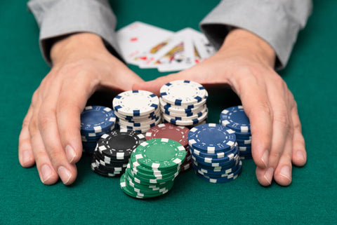A player grabs a large pot after winning a big hand in a poker tournament.