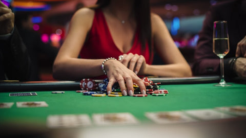 Woman collecting poker chips