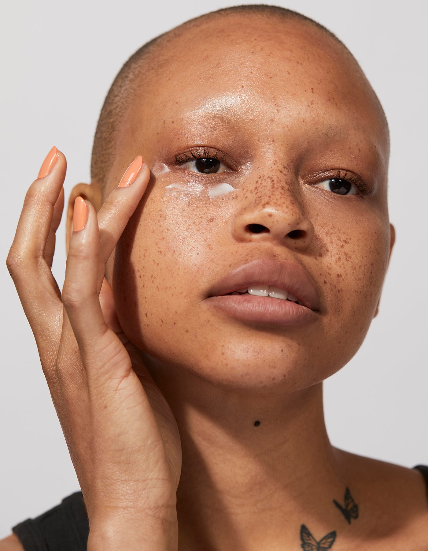 A woman applying The Eye Cream by Jones Road