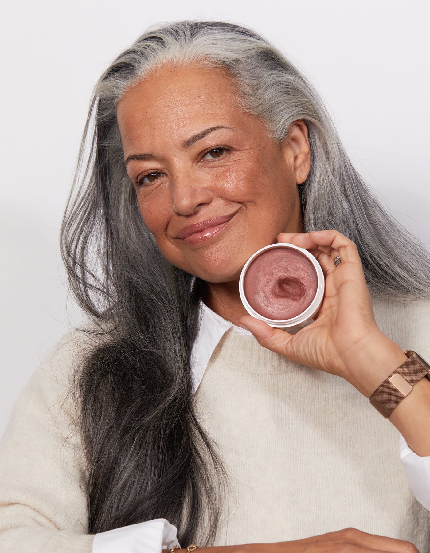 a woman holding Miracle Balm in Dusty Rose by Jones Road