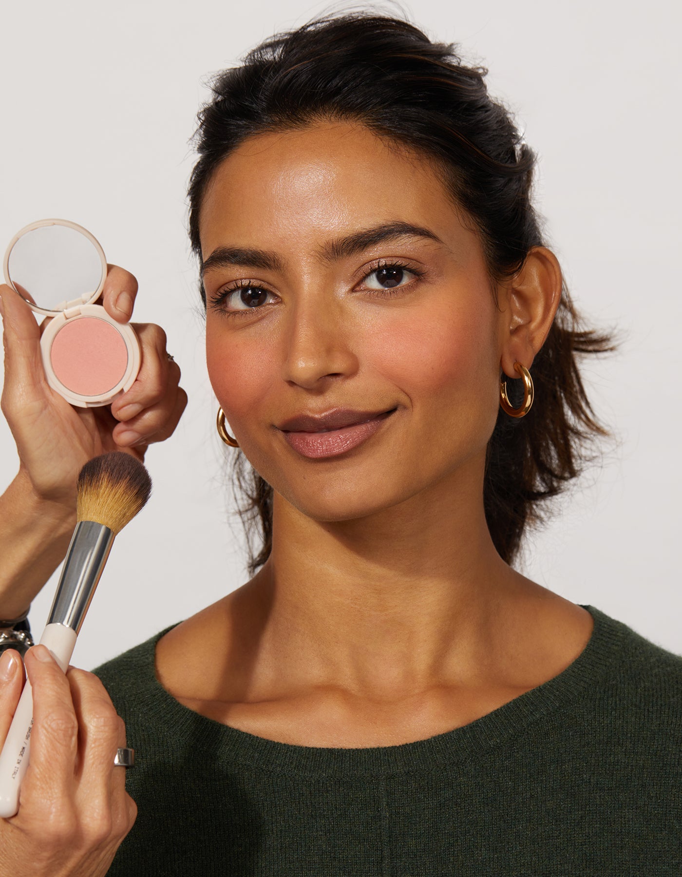 The Best Blush being applied to a woman using The Blush Brush