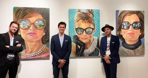 Jason, Kyle, and Guy standing next to Jackie and Audrey paintings