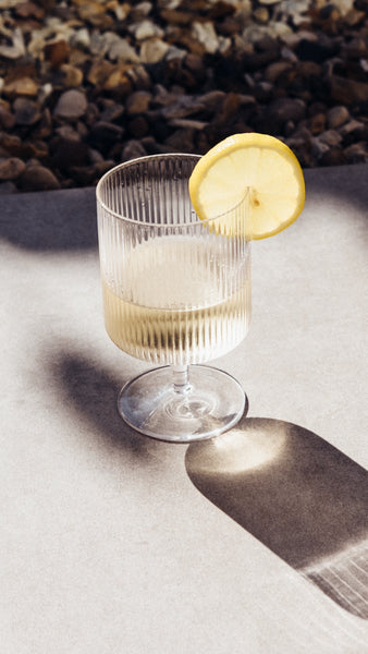 DEFY vegan organic white wine spritzer with a lemon slice in a glass