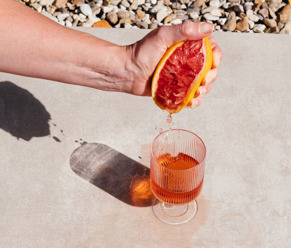DEFY vegan organic rosé wine spritzer with added fresh grapefruit juice in a glass