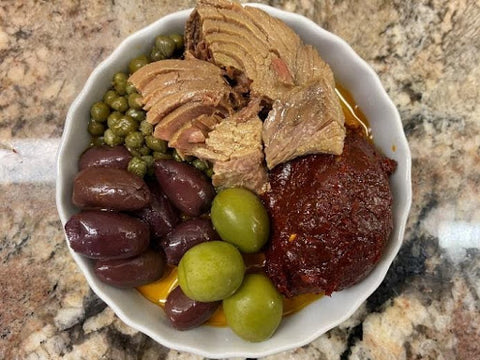 harissa diari drizzled with extra virgin olive oil, served with olives, capers, and Tunisian canned tuna