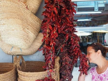 Woman smelling sun-dried chili peppers