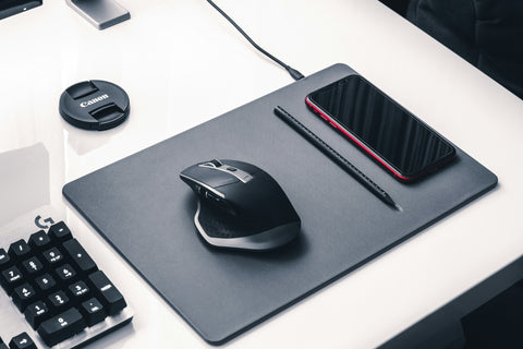 Mouse pad with mouse, phone and pencil