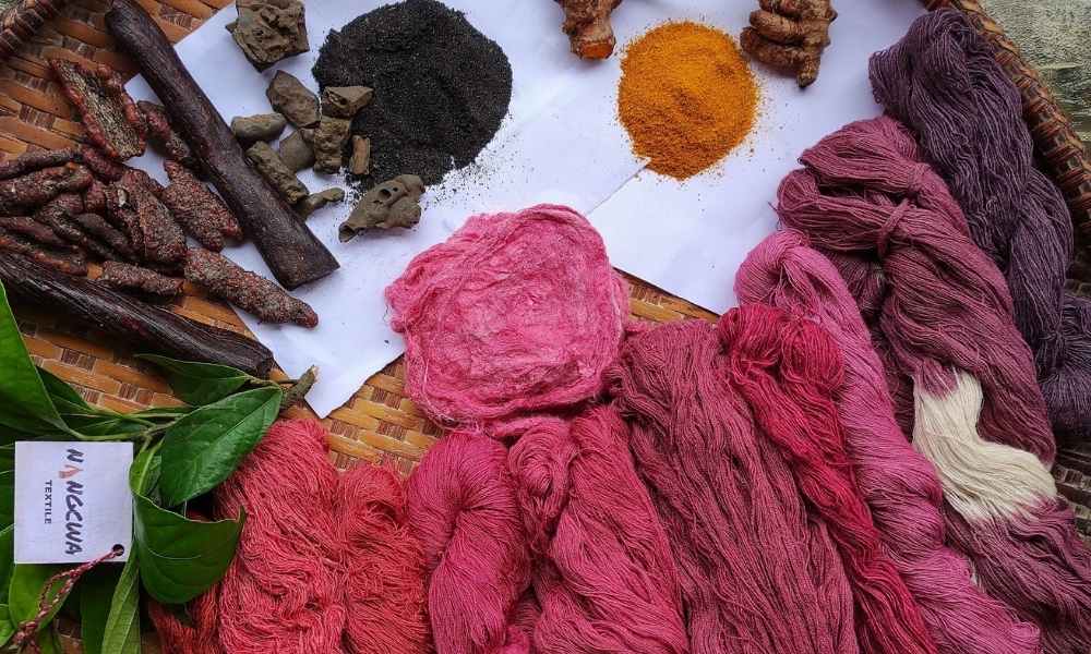Naturally dyed Silk yarn laying on a table | Muezart India