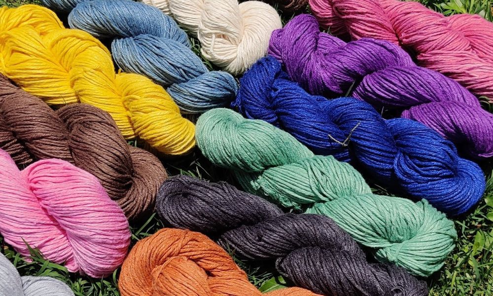 Colorful yarns stacked in a pile, perfect for knitting or crocheting your next project!