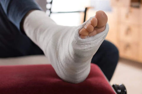 Man with white bandages wrapped around his foot