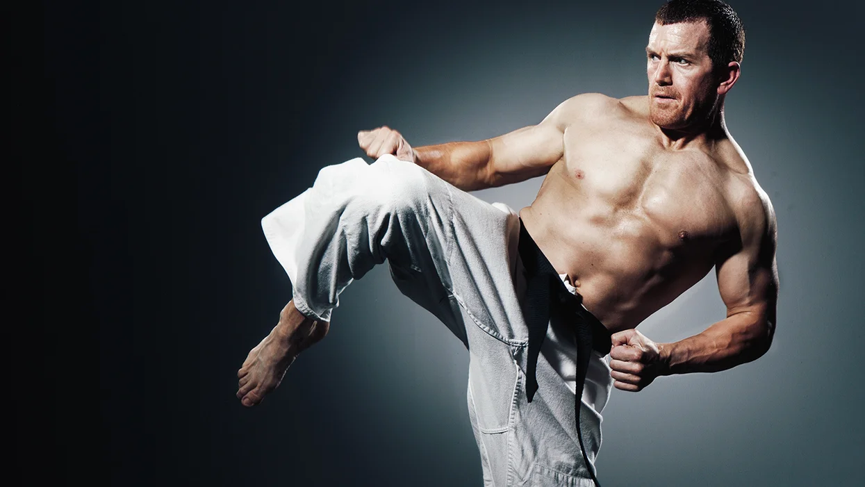 man using abdominal muscles to kick