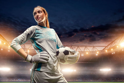 A female goalkeeper wearing the best cleats for goalkeepers