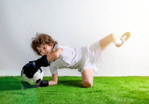 A child goalkeeper wearing the best cleats for goalkeepers