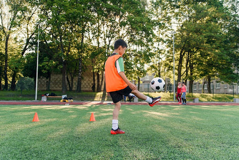 A soccer player practicing his skills using the best equipment for soccer training.