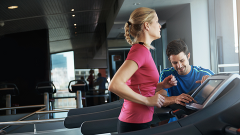 Trainer indicating the exercise to a girl