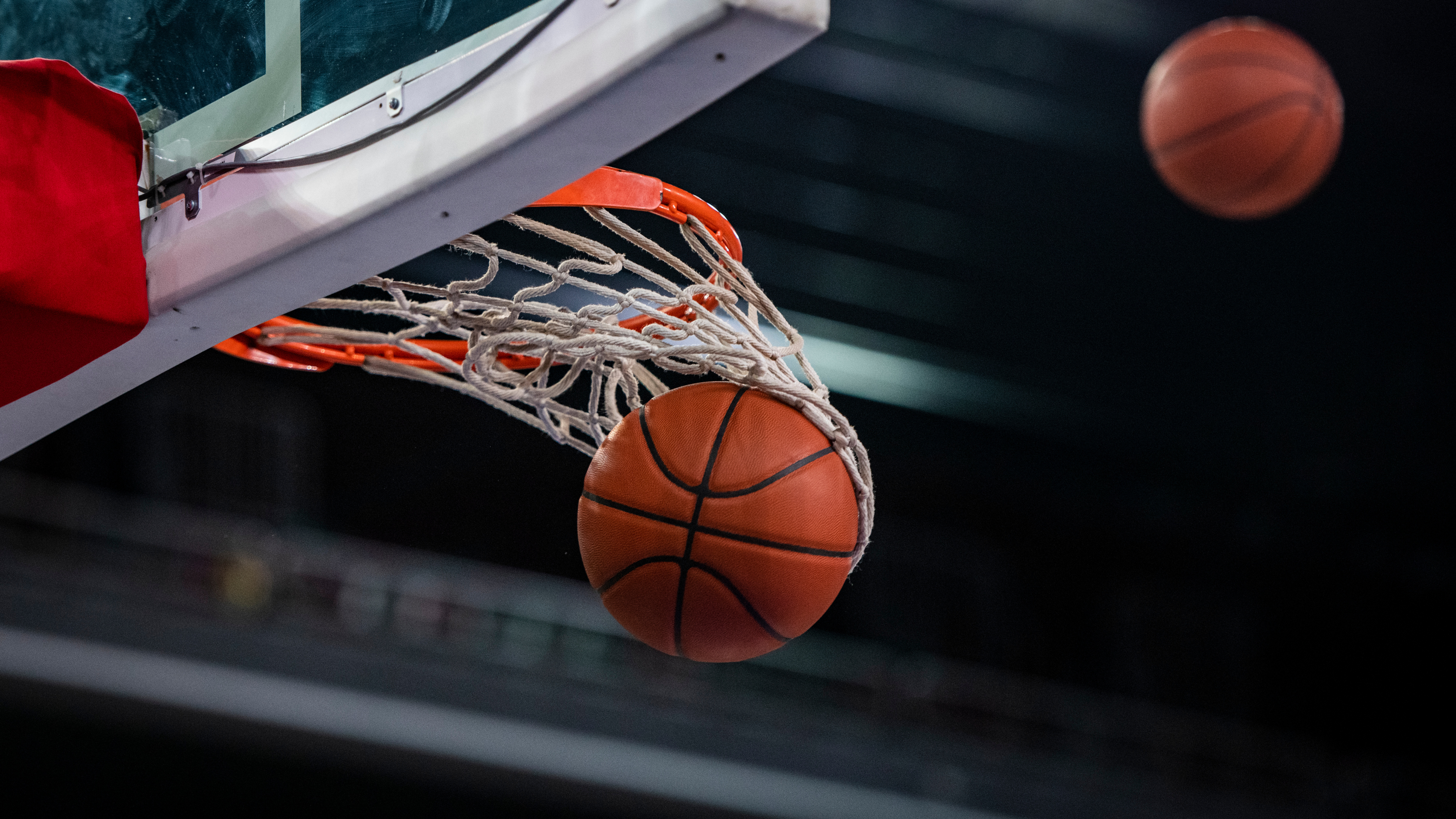 Basketball ball entering the hoop